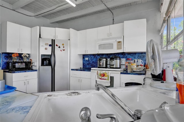 6768 Rose Dr, Miramar, FL 33023 - kitchen featuring white appliances, tasteful backsplash, white cabinetry, and beamed ceiling