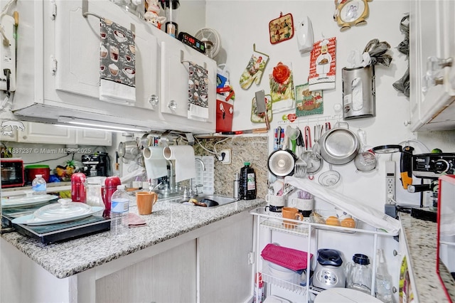 6768 Rose Dr, Miramar, FL 33023 - kitchen featuring white cabinets and tasteful backsplash