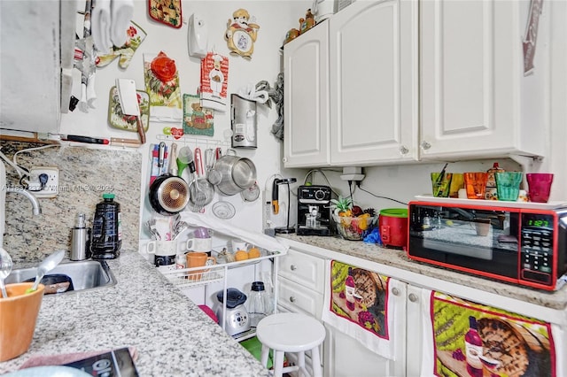 6768 Rose Dr, Miramar, FL 33023 - kitchen featuring white cabinetry, light countertops, and decorative backsplash