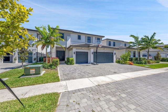 4541 SW 174th Ave, Miramar, FL 33029 - view of front facade featuring decorative driveway, a garage, a tile roof, and stucco siding