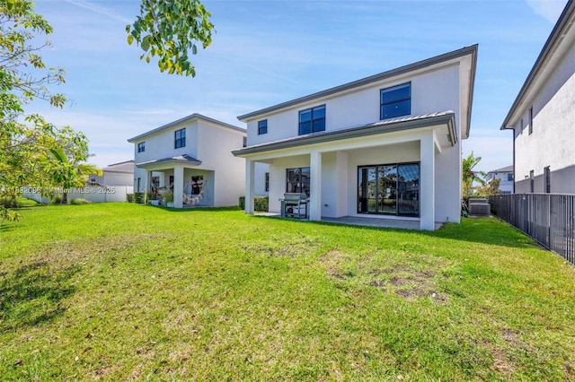4541 SW 174th Ave, Miramar, FL 33029 - back of property featuring stucco siding, a fenced backyard, a metal roof, and a standing seam roof