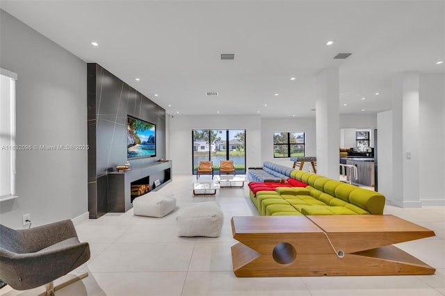 4541 SW 174th Ave, Miramar, FL 33029 - living area with recessed lighting, a lit fireplace, and tile patterned floors