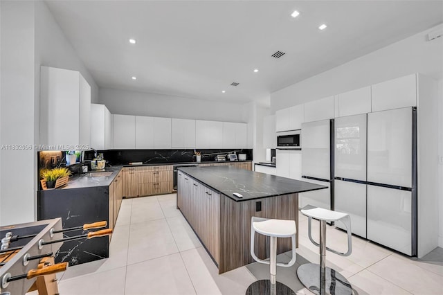 4541 SW 174th Ave, Miramar, FL 33029 - kitchen featuring freestanding refrigerator, built in microwave, modern cabinets, a kitchen island, and light tile patterned floors