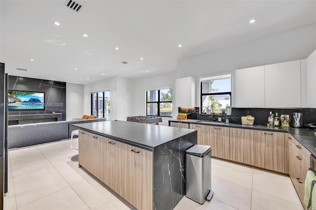 4541 SW 174th Ave, Miramar, FL 33029 - kitchen with dark countertops, modern cabinets, open floor plan, a kitchen island, and light tile patterned floors
