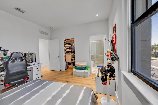 4541 SW 174th Ave, Miramar, FL 33029 - bedroom featuring light wood-style floors, a walk in closet, a desk, and ensuite bathroom