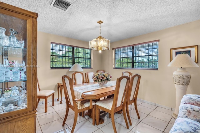 13325 SW 32nd St, Miami, FL 33175 - dining area with a chandelier, healthy amount of natural light, light tile patterned floors, and a textured ceiling