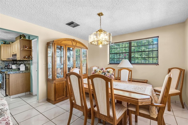13325 SW 32nd St, Miami, FL 33175 - dining space featuring healthy amount of natural light, a chandelier, a textured ceiling, and light tile patterned floors