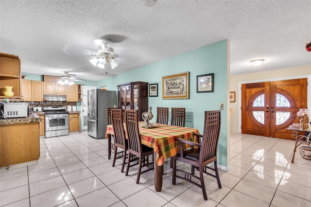13325 SW 32nd St, Miami, FL 33175 - dining area featuring light tile patterned flooring, french doors, a ceiling fan, and a textured ceiling