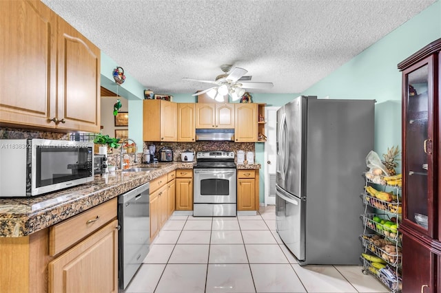 13325 SW 32nd St, Miami, FL 33175 - kitchen with stainless steel appliances, under cabinet range hood, ceiling fan, light tile patterned floors, and a textured ceiling