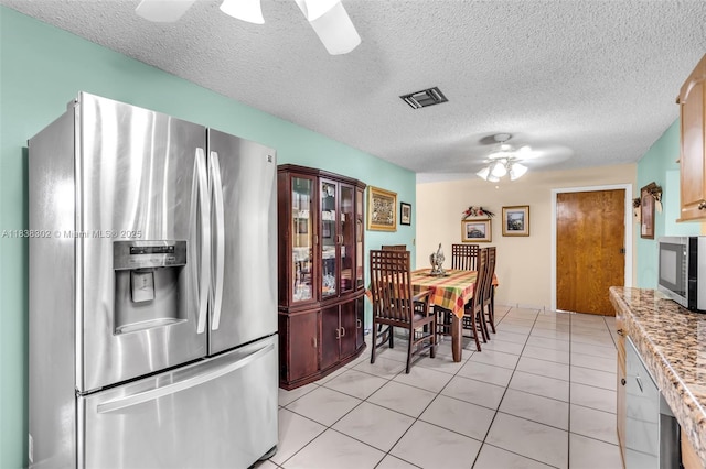 13325 SW 32nd St, Miami, FL 33175 - dining area featuring ceiling fan, light tile patterned floors, and a textured ceiling