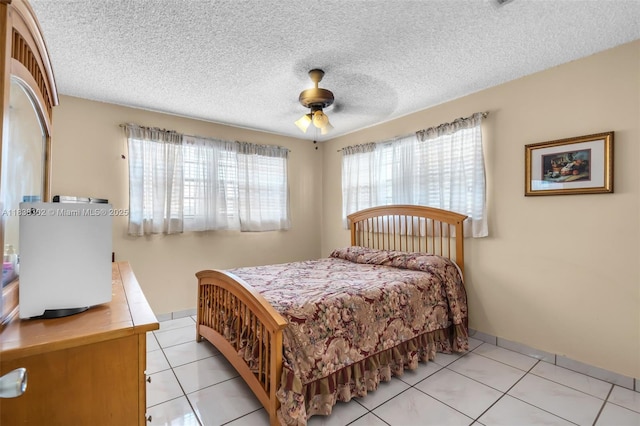 13325 SW 32nd St, Miami, FL 33175 - bedroom with light tile patterned floors, a textured ceiling, and ceiling fan