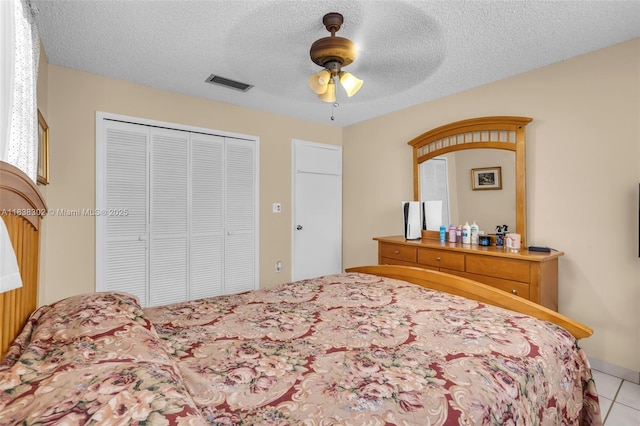 13325 SW 32nd St, Miami, FL 33175 - tiled bedroom with a closet, ceiling fan, and a textured ceiling