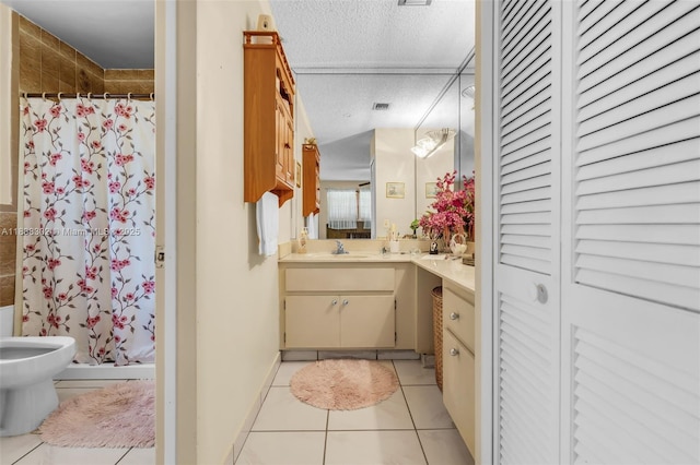 13325 SW 32nd St, Miami, FL 33175 - bathroom with a closet, vanity, a shower stall, tile patterned flooring, and a textured ceiling