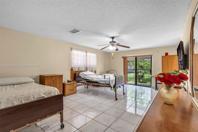 13325 SW 32nd St, Miami, FL 33175 - bedroom with light tile patterned floors, a textured ceiling, a ceiling fan, and access to exterior