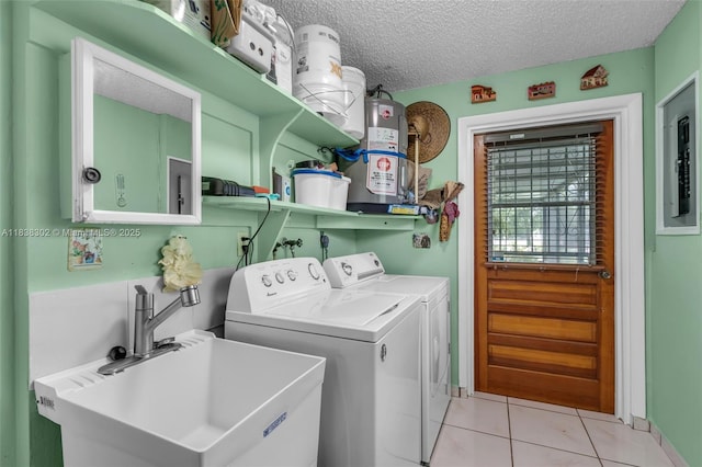 13325 SW 32nd St, Miami, FL 33175 - laundry area with gas water heater, electric panel, light tile patterned floors, washer and clothes dryer, and a textured ceiling
