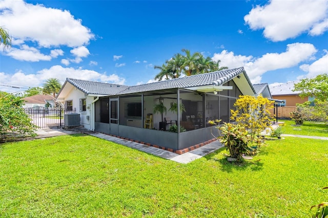 13325 SW 32nd St, Miami, FL 33175 - rear view of property featuring a sunroom, a tile roof, stucco siding, and a gate