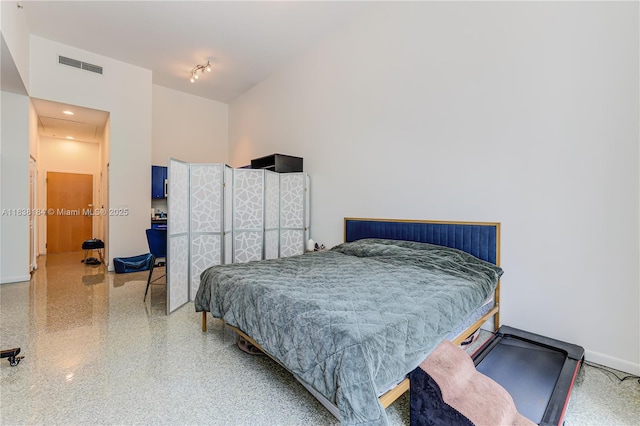 253 NE 2nd St Unit 213, Miami, FL 33132 - bedroom featuring baseboards and speckled floor