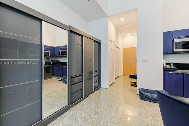 253 NE 2nd St Unit 213, Miami, FL 33132 - hall with dark aggregate flooring and recessed lighting
