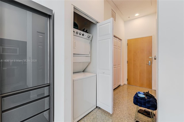 253 NE 2nd St Unit 213, Miami, FL 33132 - laundry room with stacked washing machine and dryer and recessed lighting