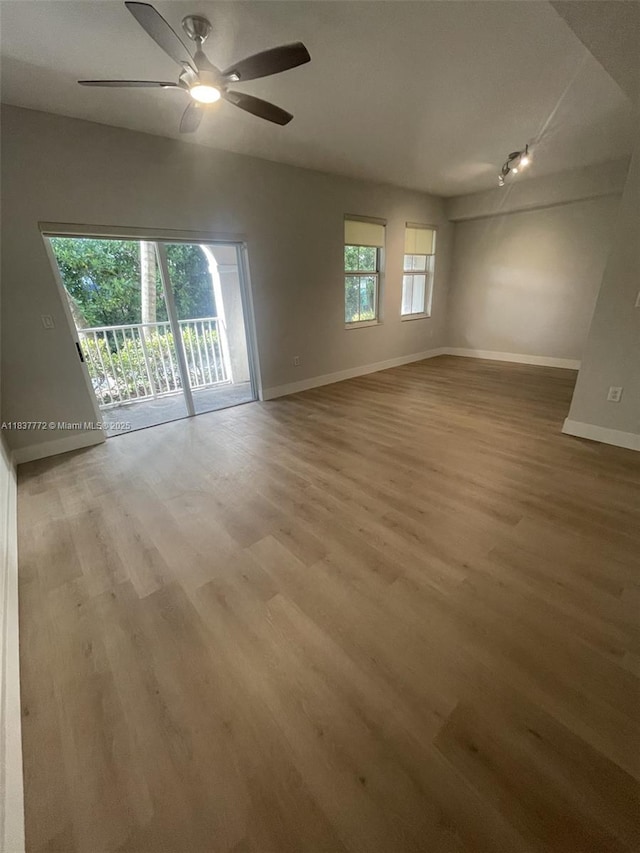 11605 NW 89th St Unit 112, Doral, FL 33178 - empty room featuring wood finished floors, ceiling fan, and rail lighting