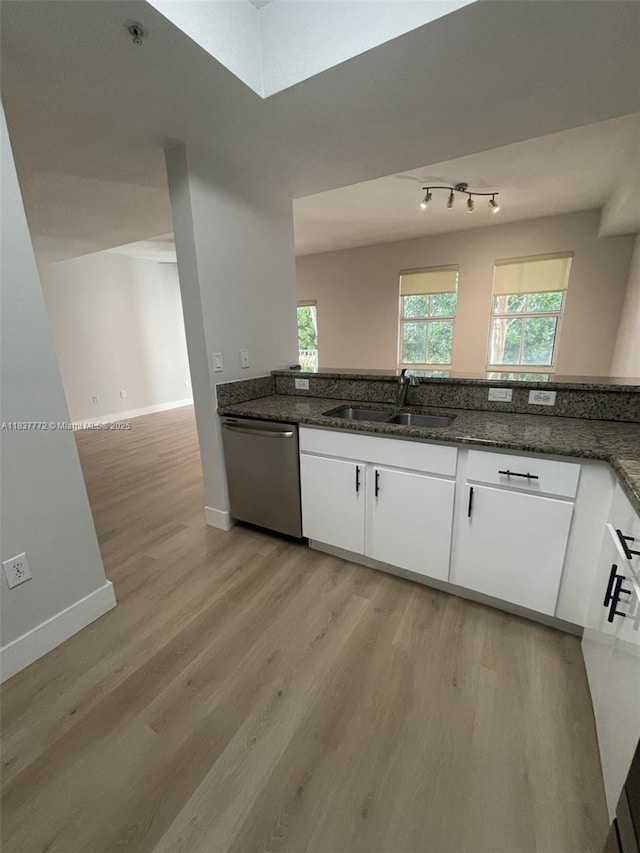 11605 NW 89th St Unit 112, Doral, FL 33178 - kitchen featuring stainless steel dishwasher, light wood finished floors, white cabinetry, and dark stone countertops