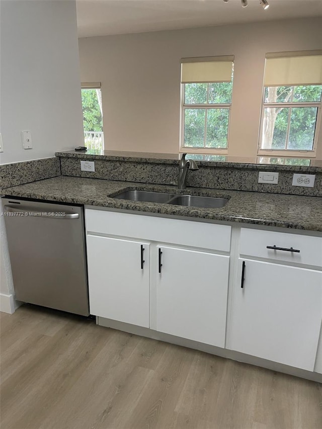 11605 NW 89th St Unit 112, Doral, FL 33178 - kitchen featuring dishwasher, dark stone counters, white cabinets, and plenty of natural light