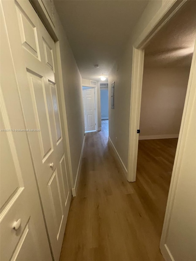 11605 NW 89th St Unit 112, Doral, FL 33178 - hallway featuring wood finished floors and electric panel