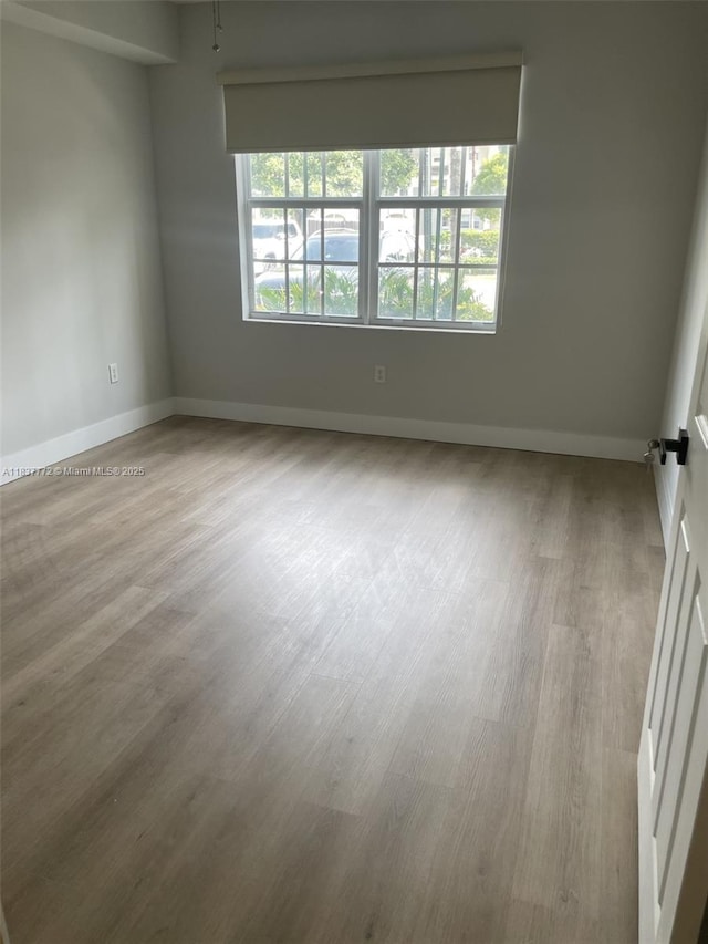 11605 NW 89th St Unit 112, Doral, FL 33178 - spare room featuring wood finished floors