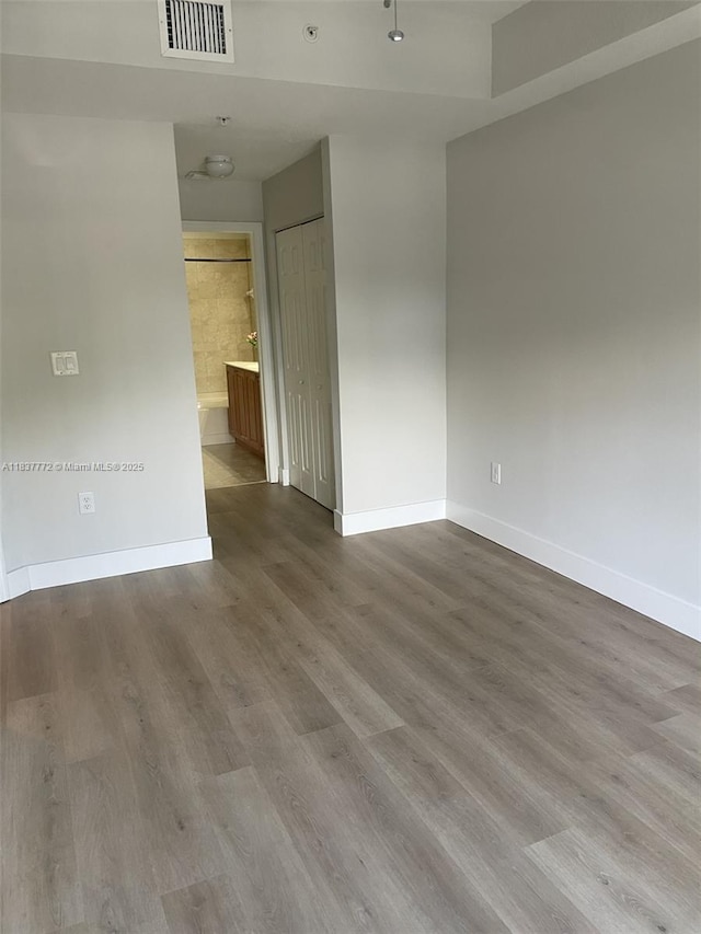 11605 NW 89th St Unit 112, Doral, FL 33178 - unfurnished room featuring baseboards and wood finished floors