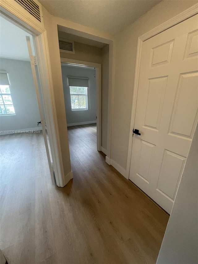 11605 NW 89th St Unit 112, Doral, FL 33178 - hallway featuring wood finished floors and baseboards