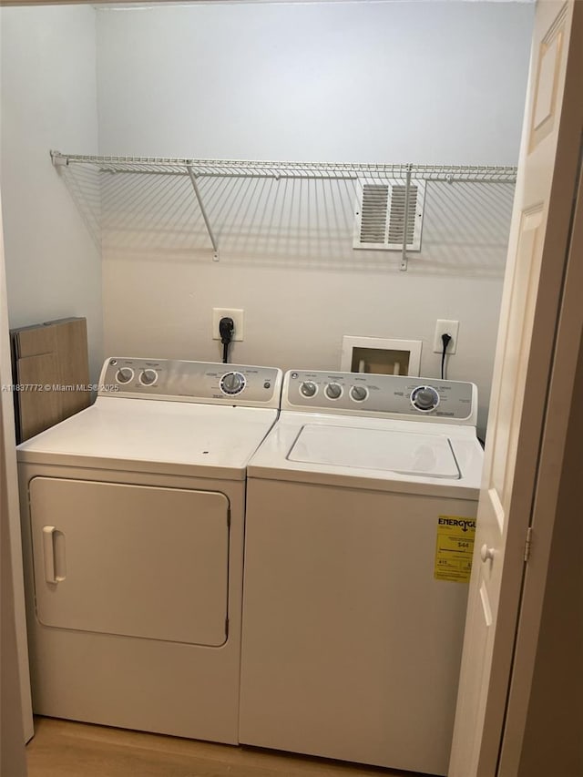 11605 NW 89th St Unit 112, Doral, FL 33178 - laundry area featuring washer and dryer and light wood-style floors