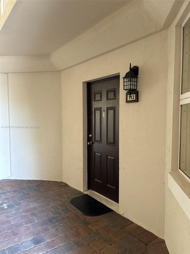 11605 NW 89th St Unit 112, Doral, FL 33178 - view of exterior entry featuring stucco siding