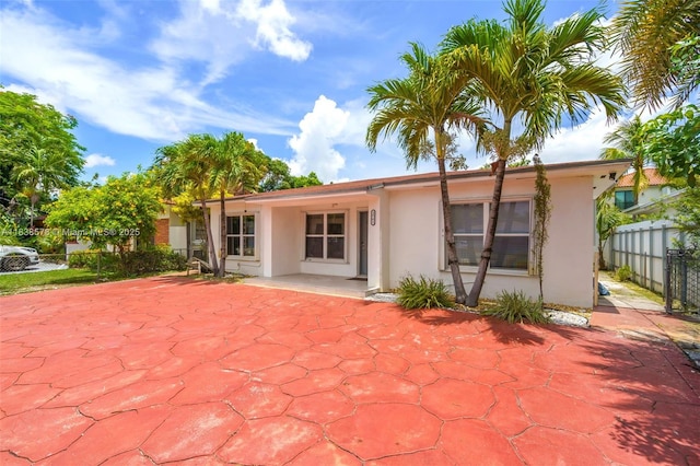 2761 SW 33rd Ct, Miami, FL 33133 - rear view of house featuring stucco siding and a patio area