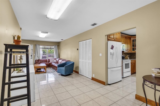 2761 SW 33rd Ct, Miami, FL 33133 - kitchen with white appliances, brown cabinets, light tile patterned floors, tasteful backsplash, and glass insert cabinets