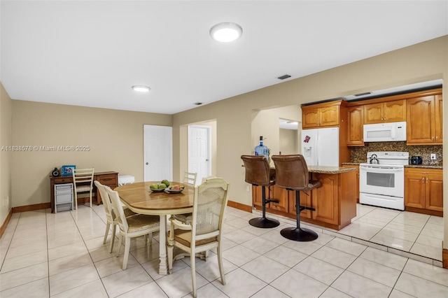 2761 SW 33rd Ct, Miami, FL 33133 - dining space with light tile patterned flooring
