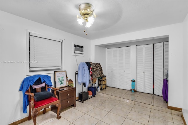 2761 SW 33rd Ct, Miami, FL 33133 - tiled bedroom with two closets, a wall unit AC, and ceiling fan