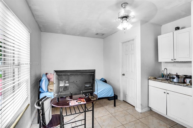 2761 SW 33rd Ct, Miami, FL 33133 - kitchen with healthy amount of natural light, white cabinetry, a ceiling fan, and light tile patterned flooring