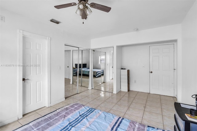 2761 SW 33rd Ct, Miami, FL 33133 - bedroom with light tile patterned flooring, two closets, and ceiling fan
