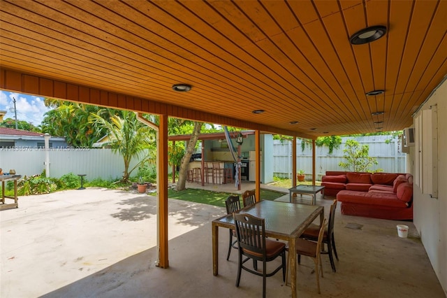 2761 SW 33rd Ct, Miami, FL 33133 - fenced backyard featuring a patio, outdoor lounge area, and outdoor dining area