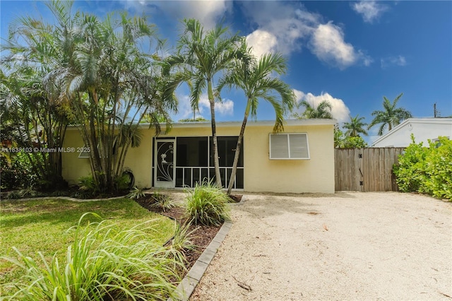 1112 N 31st Ave, Hollywood, FL 33021 - rear view of property featuring stucco siding, a sunroom, and a gate
