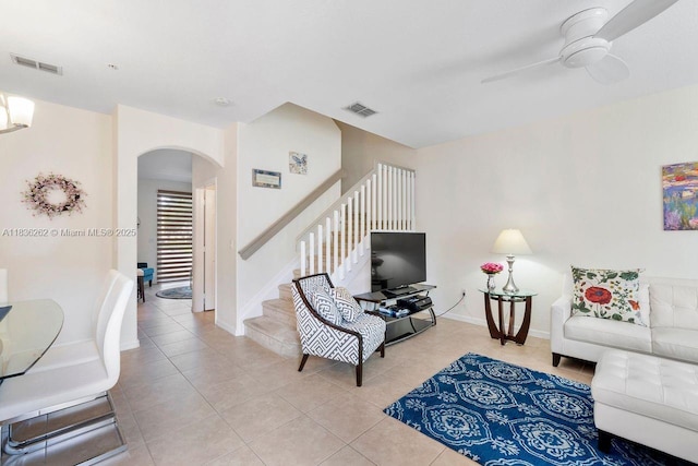 2851 W Prospect Rd Unit 1306, Tamarac, FL 33309 - living room with arched walkways, ceiling fan, light tile patterned flooring, and stairs