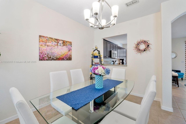 2851 W Prospect Rd Unit 1306, Tamarac, FL 33309 - dining area featuring arched walkways, a chandelier, and light tile patterned floors