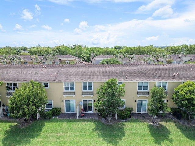 2851 W Prospect Rd Unit 1306, Tamarac, FL 33309 - rear view of house with a lawn, a residential view, and stucco siding