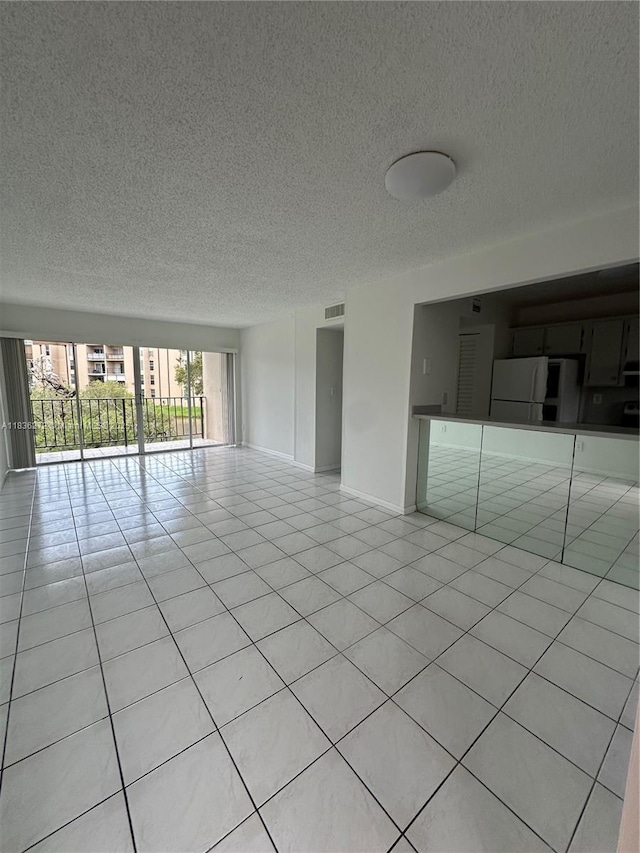 8897 Fontainebleau Blvd Unit 208, Miami, FL 33172 - unfurnished room featuring a textured ceiling and light tile patterned floors