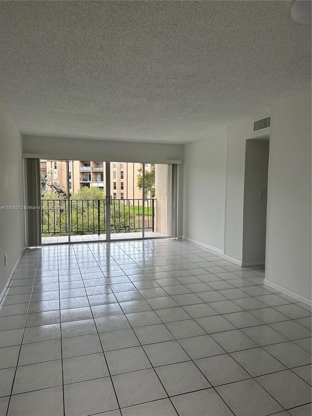 8897 Fontainebleau Blvd Unit 208, Miami, FL 33172 - unfurnished room with plenty of natural light, a textured ceiling, and light tile patterned flooring