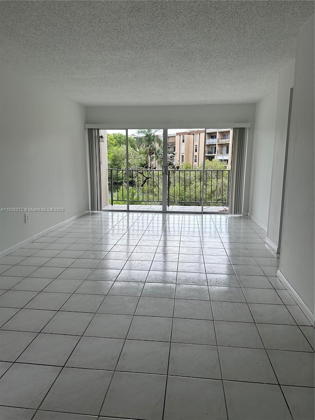 8897 Fontainebleau Blvd Unit 208, Miami, FL 33172 - unfurnished room featuring a textured ceiling and light tile patterned floors