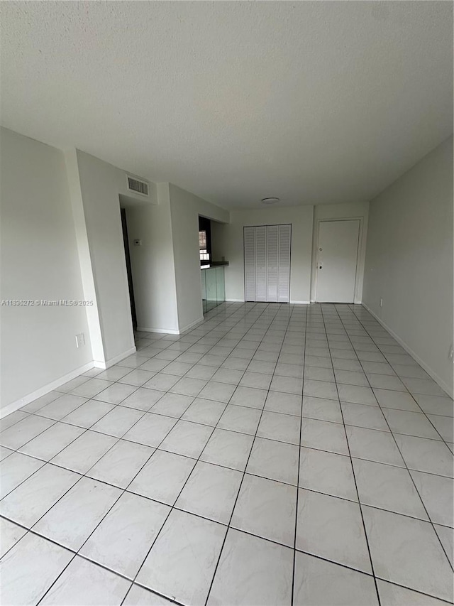 8897 Fontainebleau Blvd Unit 208, Miami, FL 33172 - empty room with a textured ceiling and light tile patterned flooring
