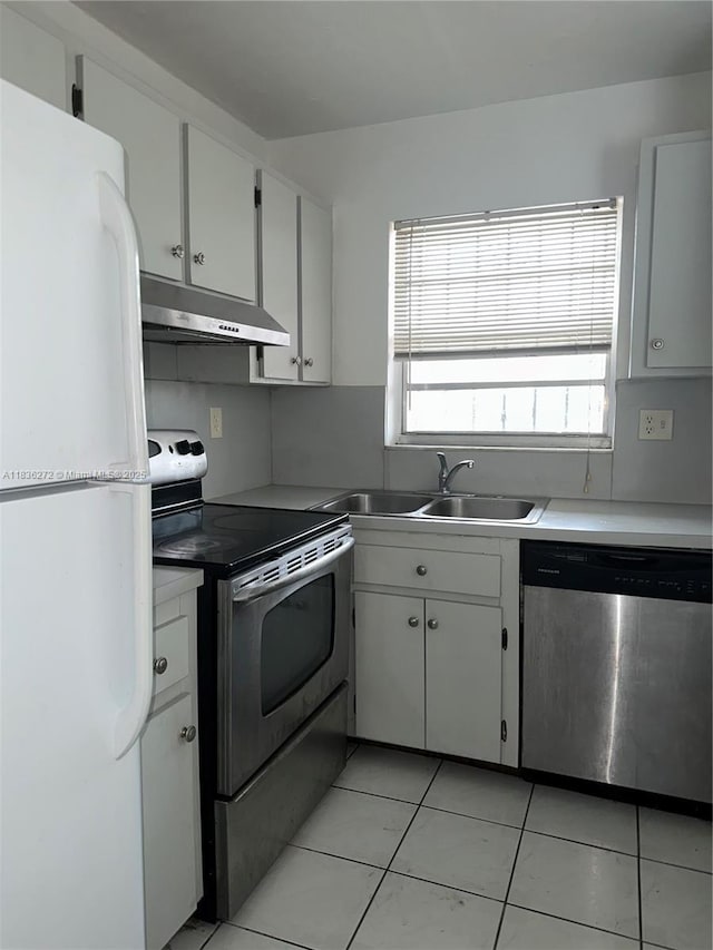 8897 Fontainebleau Blvd Unit 208, Miami, FL 33172 - kitchen featuring stainless steel appliances, under cabinet range hood, light tile patterned floors, white cabinetry, and light countertops