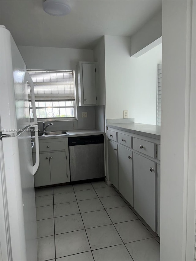 8897 Fontainebleau Blvd Unit 208, Miami, FL 33172 - kitchen featuring stainless steel dishwasher, freestanding refrigerator, light countertops, and light tile patterned floors