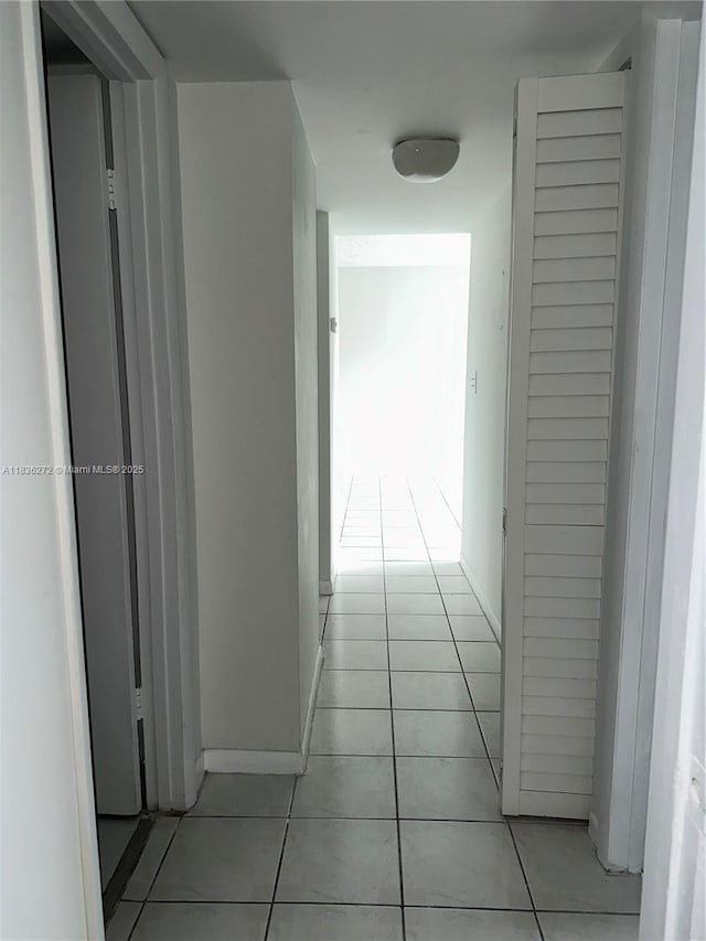 8897 Fontainebleau Blvd Unit 208, Miami, FL 33172 - corridor featuring light tile patterned floors and baseboards